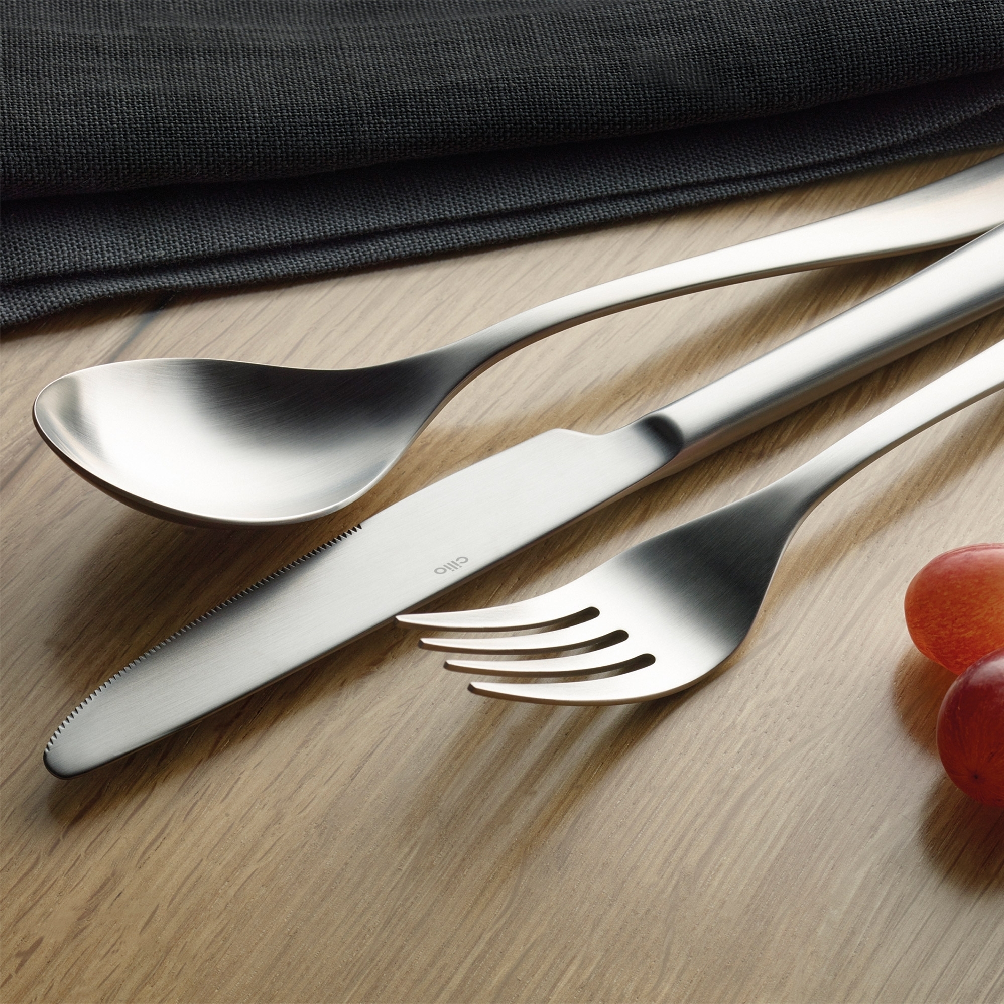 Elegant stainless steel cutlery on wooden table